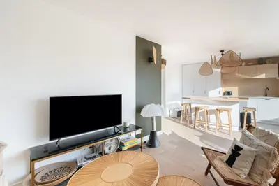 a living room with a flat screen tv on a wall at Beautiful flat with terrace - Carre d'Or Cannes in Cannes