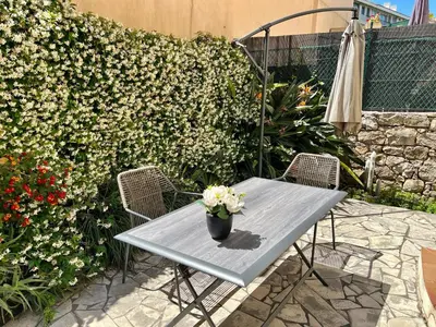 a table and chairs with a potted plant on it at Quartier Suquet Marché Forville 4 pers. Terrasse in Cannes
