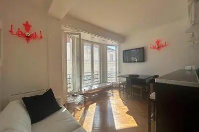 a living room with a white couch and a table at Haven of peace overlooking the Croisette in Cannes