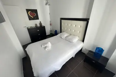 a bedroom with a white bed with two white pillows at Haven of peace overlooking the Croisette in Cannes