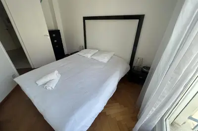 a bedroom with a white bed with two towels on it at Haven of peace overlooking the Croisette in Cannes