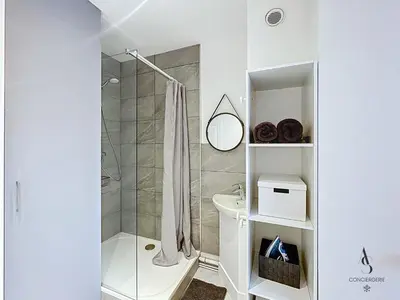 a white bathroom with a shower and a toilet at L'horloge I - Studio - 15 min Palais - Cannes in Cannes