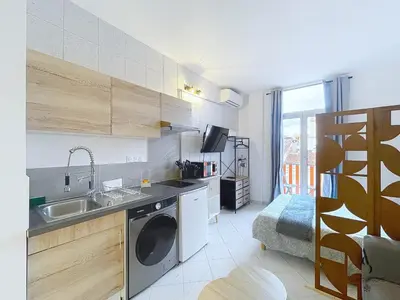 a kitchen with a sink and a washing machine at L'horloge I - Studio - 15 min Palais - Cannes in Cannes
