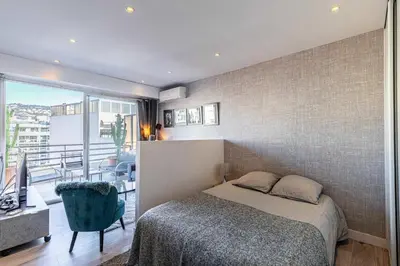 a bedroom with a bed and a balcony at Magnificent studio with terrace - center of Cannes in Cannes
