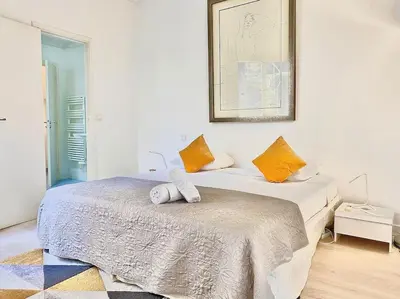 a bedroom with two beds and a picture on the wall at Appartements Cannes 3 chambres - 8B1 in Cannes