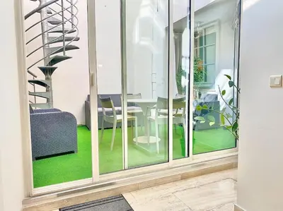 a room with a glass door with a table and chairs at Appartements Cannes 3 chambres - 8B1 in Cannes