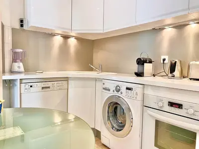 a kitchen with a washing machine and a sink at Appartements Cannes 3 chambres - 8B1 in Cannes