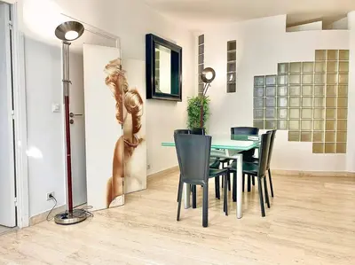 a dining room with a table and chairs at Appartements Cannes 3 chambres - 8B1 in Cannes