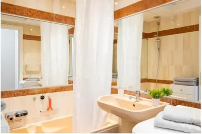 a bathroom with a sink and a mirror at L'Ariane - Studio - 5 min Plage - Climatisé in Cannes