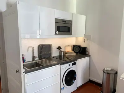 a kitchen with a washing machine and a microwave at THE HEART OF CANNES 5MIN BY LA CROISETTE AND BEACH in Cannes
