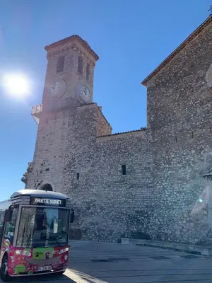 a bus parked in front of a building with a clock tower at THE HEART OF CANNES 5MIN BY LA CROISETTE AND BEACH in Cannes