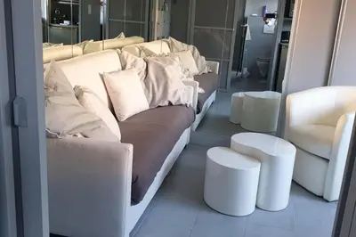 a living room with a couch and two white chairs at Studio Croisette in Cannes