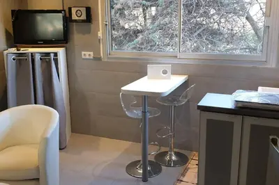 a room with a table and a tv and a stool at Studio Croisette in Cannes