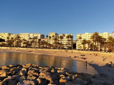 a beach with a bunch of people in the water at Studio Croisette in Cannes