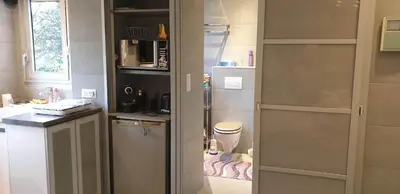 a small kitchen with a refrigerator and a sink at Studio Croisette in Cannes