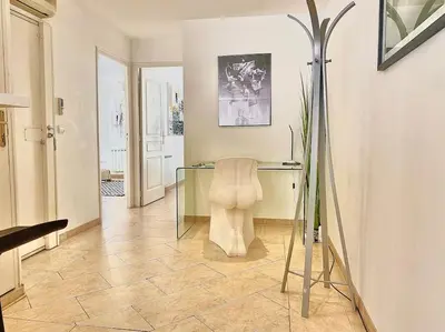 a room with a glass desk and a chair at Appartement Cannes 3 chambres - 8B2 in Cannes