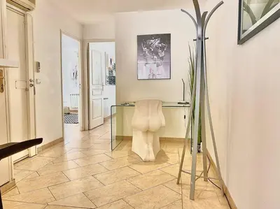 a room with a glass table and a chair at Appartement Cannes 3 chambres - 8B2 in Cannes