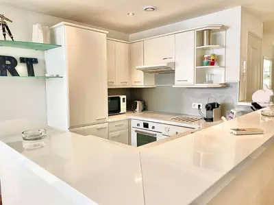a kitchen with white cabinets and a white counter top at Appartement Cannes 6 chambres - 8B3 in Cannes
