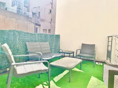 three chairs and a table on a balcony at Appartement Cannes 6 chambres - 8B3 in Cannes