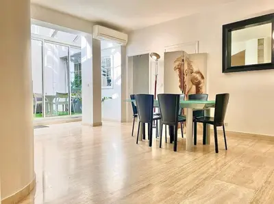 a dining room with a table and chairs at Appartement Cannes 6 chambres - 8B3 in Cannes