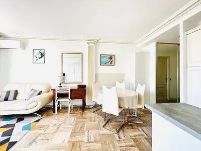a living room with a couch and a table at Le Splendide - studio croisette - vue mer in Cannes