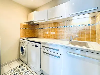 a kitchen with a washing machine and a sink at Miramar - Studio Croisette - Vue Mer Panoramique in Cannes