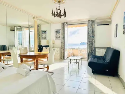 a living room with a table and a dining room at Le Belmondo - Studio Croisette - Palais Miramar in Cannes