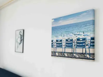 a picture of a beach with chairs and the ocean at Le Belmondo - Studio Croisette - Palais Miramar in Cannes