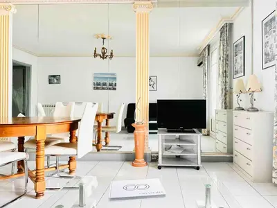 a living room with a table and a television at Le Belmondo - Studio Croisette - Palais Miramar in Cannes