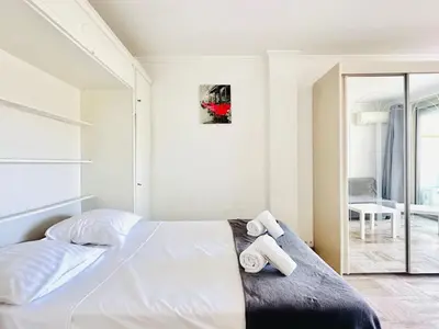 a bedroom with a bed with two towels on it at Grand Hotel - Studio Croisette in Cannes