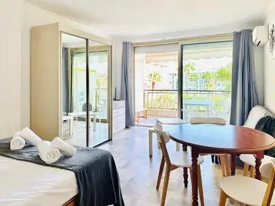 a room with a bed and a table and a dining room at Grand Hotel - Studio Croisette in Cannes