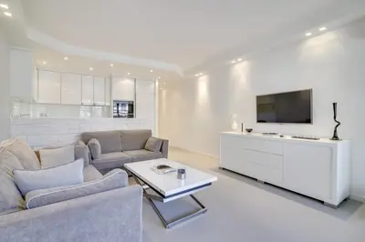 a living room with a couch and a tv at Appartement calme et confortable -terrasse- Cannes in Cannes