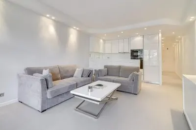 a living room with two couches and a table at Appartement calme et confortable -terrasse- Cannes in Cannes