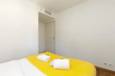 a bedroom with a bed with two towels on it at Greg YourHostHelper in Cannes