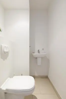a white bathroom with a toilet and a sink at Greg YourHostHelper in Cannes