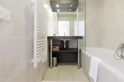 a bathroom with a tub and a sink and a bath tub at Greg YourHostHelper in Cannes