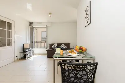 a living room with a table with fruit on it at Greg YourHostHelper in Cannes