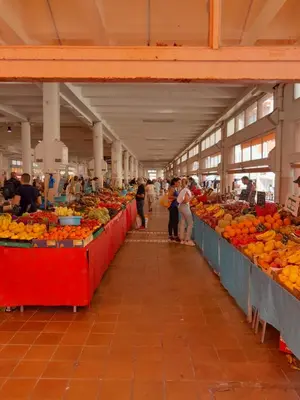 a market with many tables filled with fruits and vegetables at World Apartment Cannes in Cannes