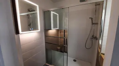a bathroom with a shower with a glass door at Sunny Mercury - Room in Apartment in Cannes