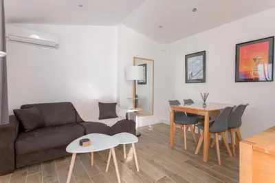 a living room with a couch and a table at Lisa's Rooftop - Toit-terrasse à 2mn du Palais et des plages de la Croisette in Cannes