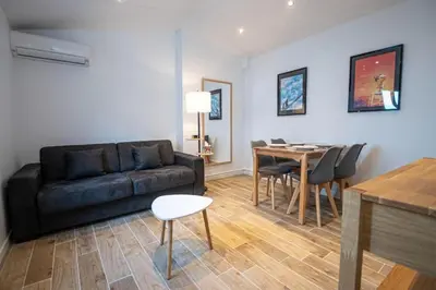 a living room with a couch and a table at Lisa's Rooftop - Toit-terrasse à 2mn du Palais et des plages de la Croisette in Cannes