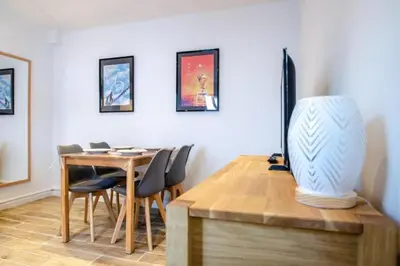a dining room with a table and a vase on a desk at Lisa's Rooftop - Toit-terrasse à 2mn du Palais et des plages de la Croisette in Cannes