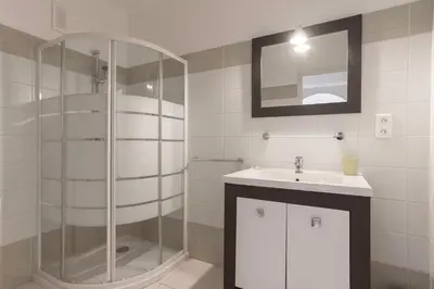 a bathroom with a glass shower and a sink at 