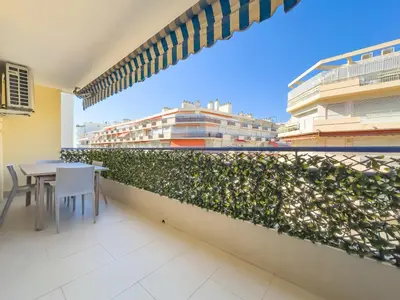 a balcony with a table and chairs and a building at Le Maubourg by Winsome Destination in Cannes