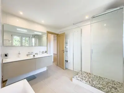 a bathroom with a glass shower and a sink at Le Maubourg by Winsome Destination in Cannes