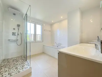 a bathroom with a shower and a sink and a tub at Le Maubourg by Winsome Destination in Cannes