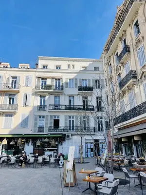 a large building with tables and chairs in a courtyard at ANNA CLAIRE festival plages GAZ5213 in Cannes