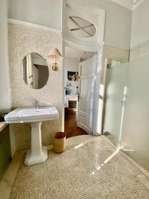 a bathroom with a sink and a shower with a mirror at ANNA CLAIRE festival plages GAZ5213 in Cannes