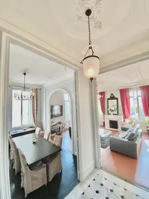 a dining room with a table and a living room at ANNA CLAIRE festival plages GAZ5213 in Cannes