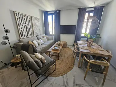 a living room with a couch and a table at PALOMA in Cannes